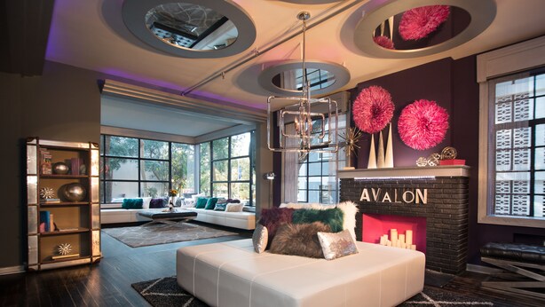 A modern living room with a fireplace, a white sofa, and a bookshelf. - Avalon Hotel Downtown St. Petersburg (St. Petersburg)