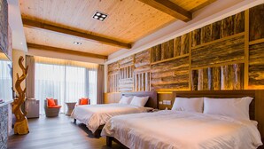 A hotel room with two beds, wooden flooring, a stone wall, and a large window with curtains. - Star of Bethlehem BnB (Wujie)