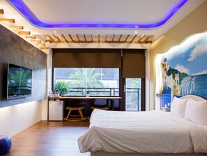 A modern hotel room with a bed, a desk, a TV, and a balcony with a view of palm trees. - Star of Bethlehem BnB (Wujie)