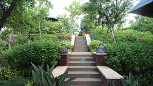 A staircase surrounded by lush greenery leading to a building. - Country Garden Golden Beach Spring Hotel (Lingao)