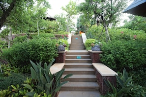 A staircase surrounded by lush greenery leading to a building. - Country Garden Golden Beach Spring Hotel (Lingao)