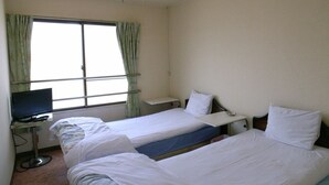 A hotel room with two single beds, a desk with a computer, and a window with curtains. - Tabist Hirofune Koyo IC (Nagoya)