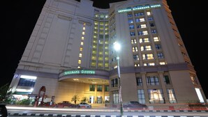 A hotel with a prominent Imperial Riverbank Hotel sign, a large entrance with a curved facade, and a well-lit corner. - Imperial Riverbank Hotel Kuching (Kuching)
