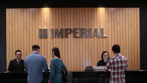 A reception desk with a wooden panel wall and the word "IMPERIAL" above it. - Imperial Riverbank Hotel Kuching (Kuching)