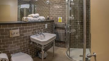Un baño con ducha, inodoro y lavabo.