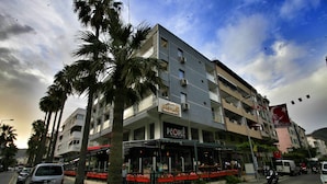 A multi-story hotel with a storefront named "People" on the ground floor, featuring outdoor seating and a red awning. - The Marmaris Boutique Hotel (Marmaris)