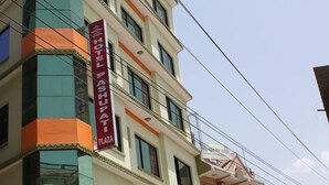 A multi-story building with a prominent red sign for 'Hotel Pashupati Plaza'. - Pashupati Plaza (Kathmandu)