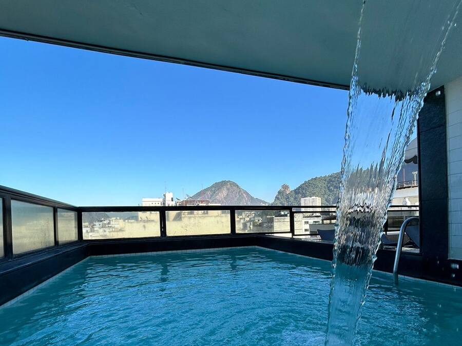 Una piscina al aire libre, sillones reclinables de piscina