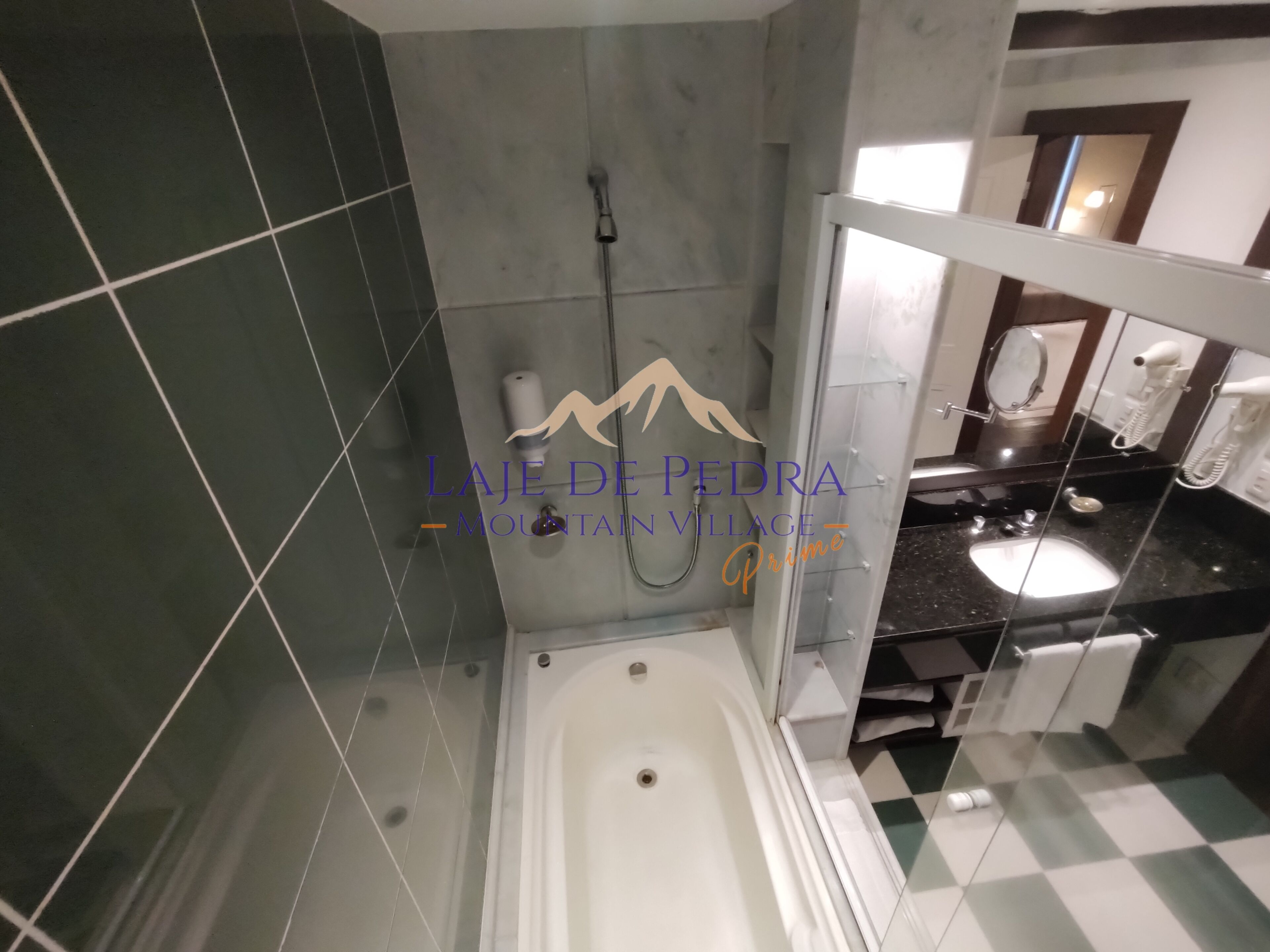 Un baño moderno con bañera, ducha y tocador con espejo.