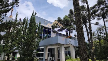 Welcome to our hotel, featuring a sleek entrance and beautifully landscaped surroundings.