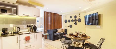 Standard Apartment, 2 Double Beds | Living area | Flat-screen TV, iPod dock
