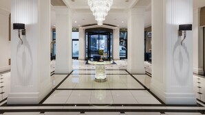 A grand lobby with a central chandelier, white columns, and a polished floor. - Eurostars Danube Budapest (Budapest)