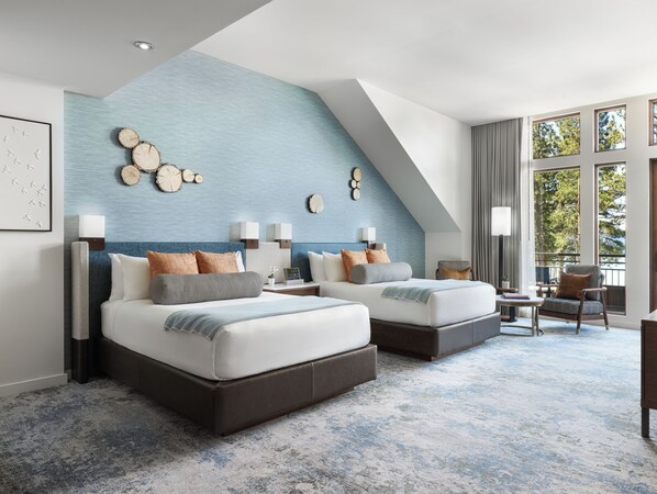 A modern hotel room with two beds, a large window, and a view of trees. - Edgewood Tahoe Resort (Stateline)