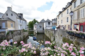 Stroll along the tranquil canal, surrounded by historic buildings and blooming flowers.