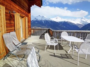 Enjoy breathtaking views of the surrounding mountains from the balcony of this cozy cabin.