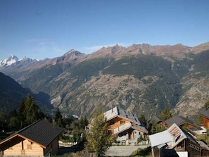 Escape to a rustic mountain retreat surrounded by dense forests and towering peaks.
