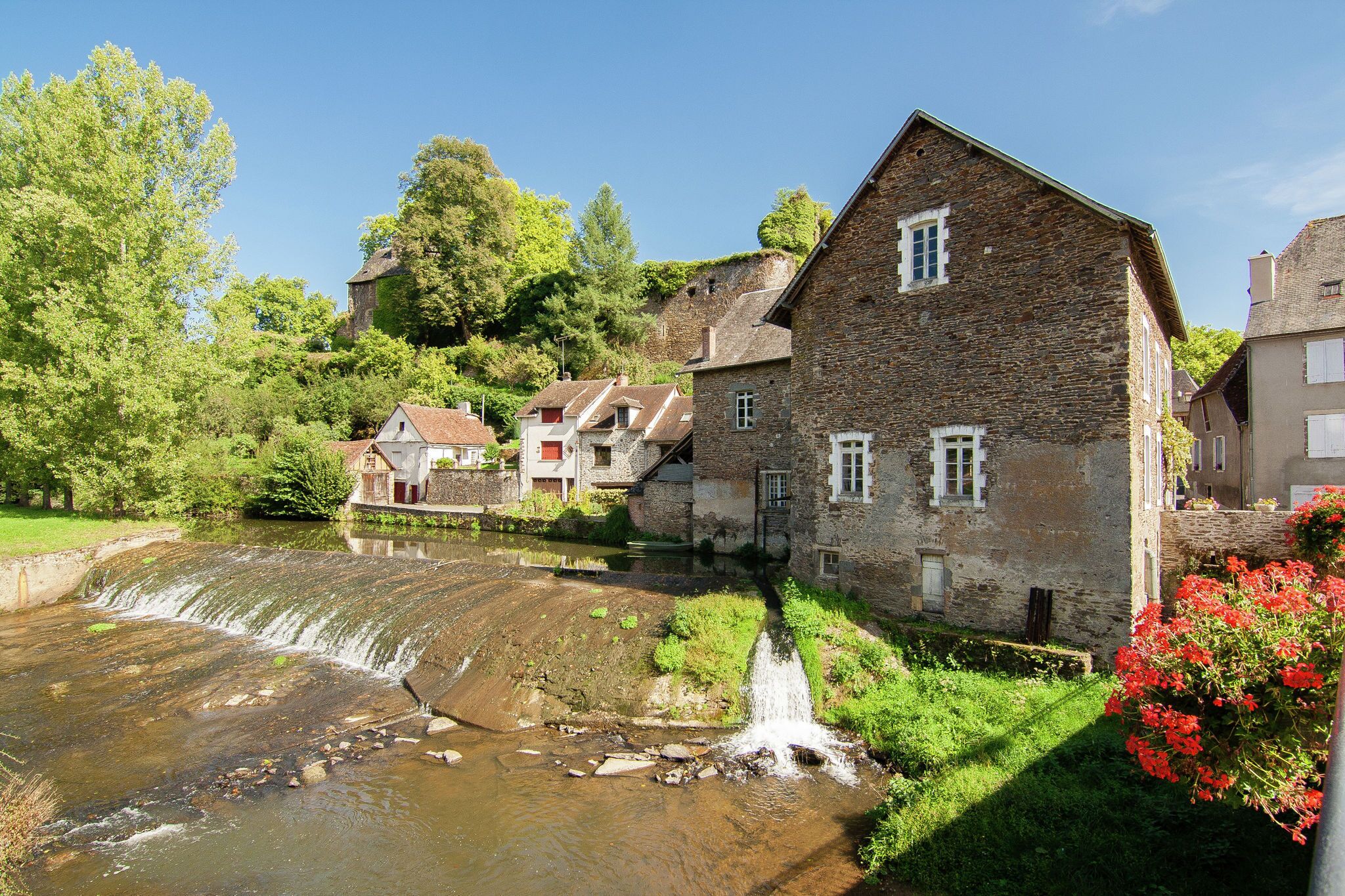 A stone building with a water feature in front.