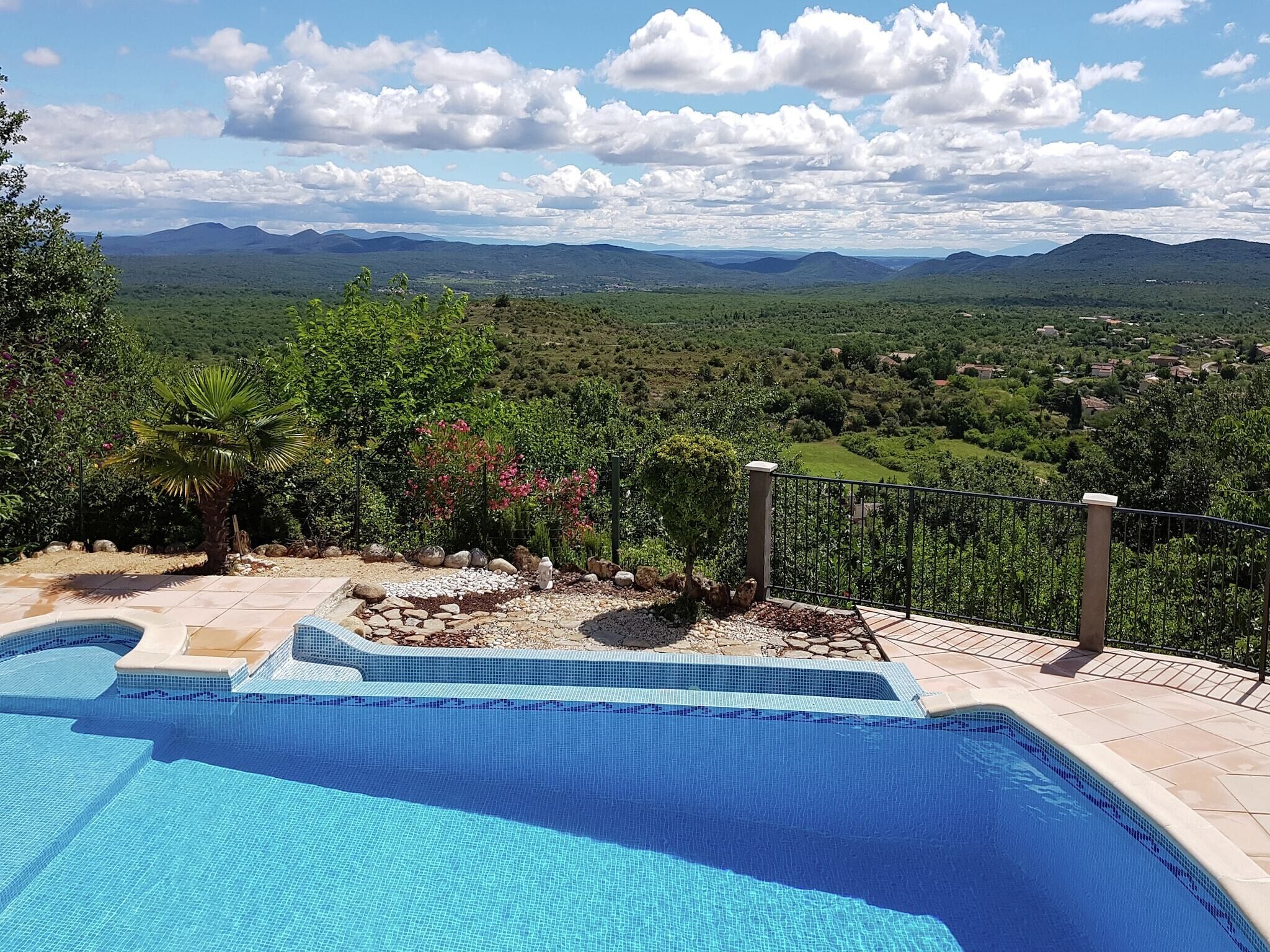 A swimming pool with a view of a mountainous landscape.