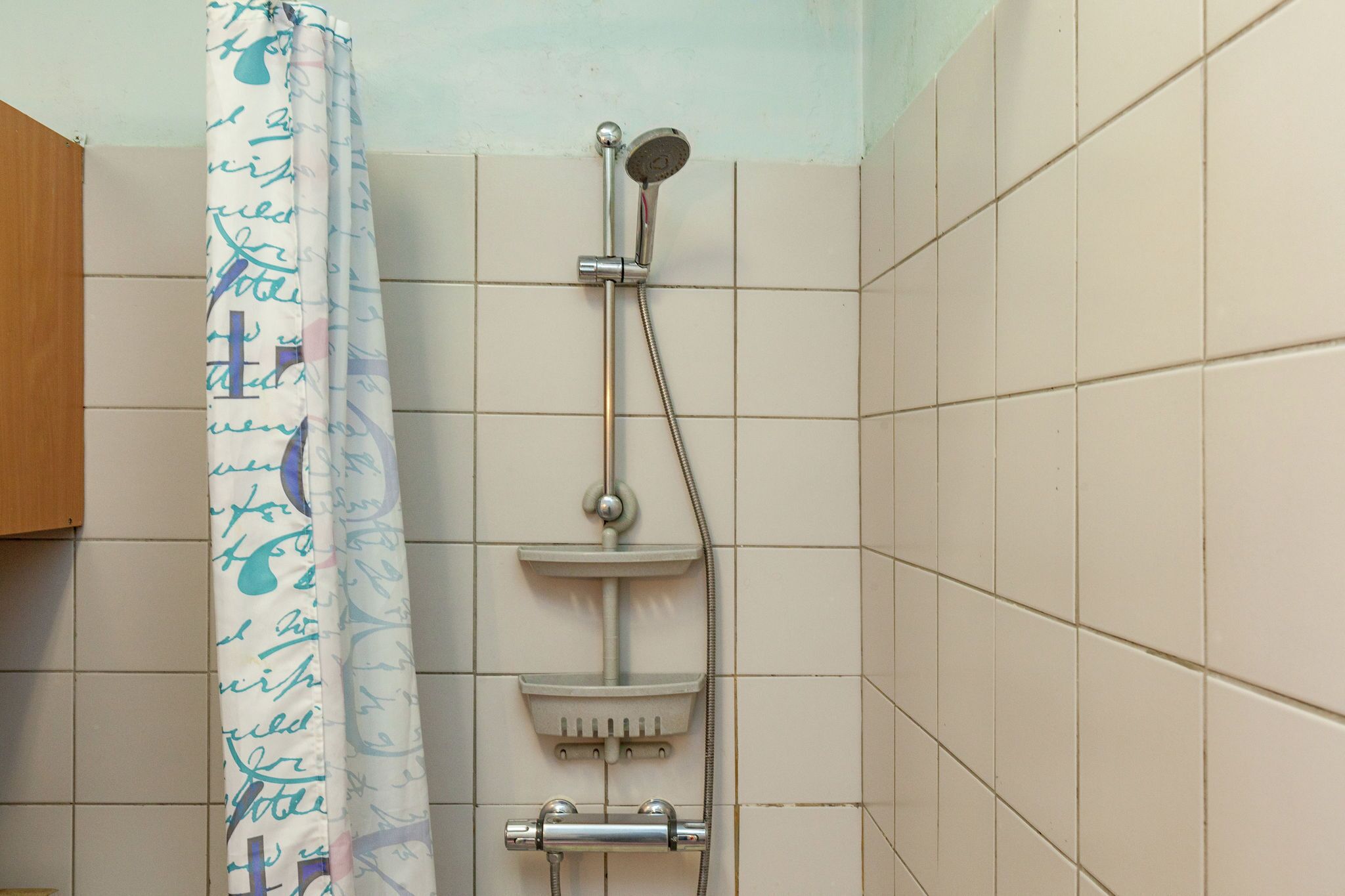 Ducha con cabezal de ducha de mano y grifo empotrado.