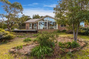 Enjoy a serene atmosphere from the spacious deck overlooking the beautifully landscaped garden.