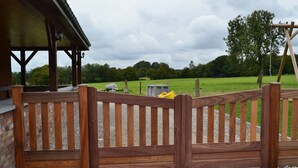 A wooden gate leading to a covered outdoor area with a gravel path.