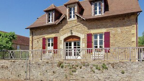 A stone house with a stone facade, red shutters, and a tiled roof. - Elegant Villa in Saint-Médard (St. Medard D'excideuil)