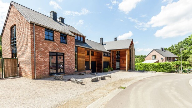 A modern two-story house with a brick facade, large windows, and a wooden front door. - Elegant Villa in Bomal (Bomal-Sur-Ourthe)