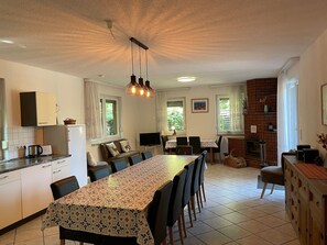 Enjoy meals in the kitchen and dining area with a large island table and comfortable seating.