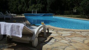 A swimming pool with lounge chairs and a covered area. - Holiday Home in Quend-Plage near Forest (Quend-Plage)