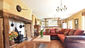 A cozy living room with a fireplace, a sofa, and a coffee table.