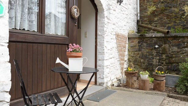 A wooden door with a white wall and a black lantern above it. - Former farmhouse in a quiet village (Manhay-Freyneux)