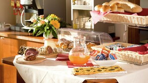 A breakfast buffet with various pastries, bread, and a coffee machine. - Romantic Countryside Escape (Cannara Assisi)