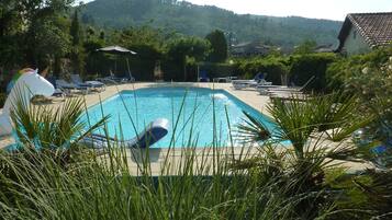 Relax by the serene pool surrounded by lush greenery and enjoy the scenic views.