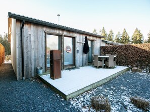 A wooden building with a glass door and a sign reading "le chalet".