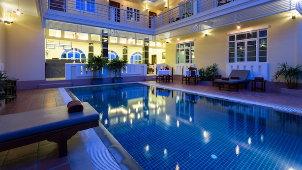 A multi-level hotel with a swimming pool, outdoor seating, and multiple balconies. - Grand Bayon Siem Reap Hotel (Siem Reap)