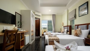 A hotel room with two beds, a desk, a TV, and a window with a view. - Grand Bayon Siem Reap Hotel (Siem Reap)