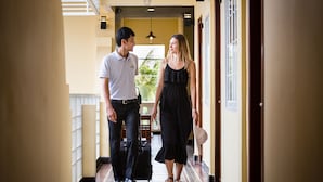 A hotel corridor with a tiled floor, a staircase, and a view of the outdoors. - Grand Bayon Siem Reap Hotel (Siem Reap)