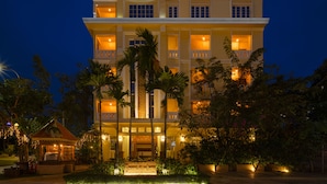 A multi-story hotel with a grand entrance, palm trees, and well-lit surroundings. - Grand Bayon Siem Reap Hotel (Siem Reap)