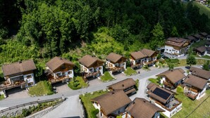 A residential area with multiple houses, each with a sloped roof and wooden balconies.