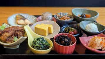 A variety of dishes on a tray, including fried items, a block of tofu, and several small bowls containing different foods.