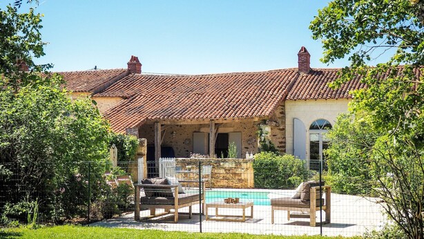 A villa with a tiled roof, a swimming pool, outdoor furniture, and a garden. - Holiday Home Saint-Laurent Pool & Garden (St. Laurent de la Salle)
