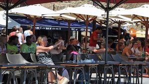 An outdoor café with tables and umbrellas.