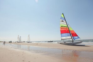 Sailboats dot the horizon, inviting guests to enjoy a leisurely day on the water.