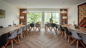 A modern dining room with a long table, chairs, and pendant lights. - Pet-Friendly Mansion (Swolgen)