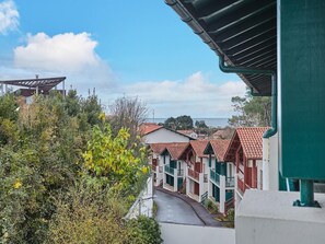 A coastal hotel with multiple-story buildings, a paved pathway, and a view of the sea. - Coast Retreat with Terrace (Saint Jean de luz)