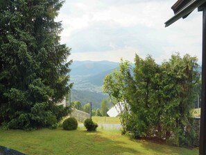 Escape to a serene natural oasis with lush greenery, a tranquil stone wall, and a picturesque bridge.