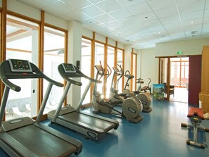 A gym with treadmills, ellipticals, and weight machines.