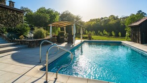 A swimming pool with a pergola and outdoor seating area. - Poolside Haven in Salles (Salles-De-Belvès)