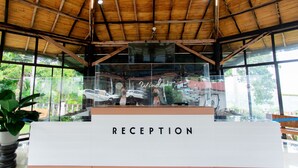 A reception area with a wooden ceiling, large windows, and a sign that reads "RECEPTION". - Ultra Winds Mountain Resort (Baungon)