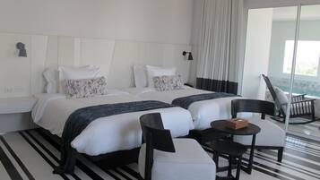 Ein Hotelzimmer mit zwei Betten, einem kleinen Tisch und einem Stuhl.